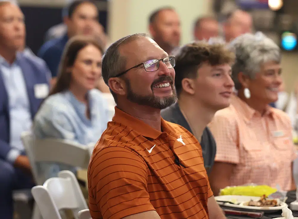 man in a orange polo shirt